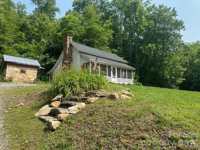 10 Chigger Ridge Road Sylva, NC 28779 - Photo 19 of 22 a front view of a house with garden