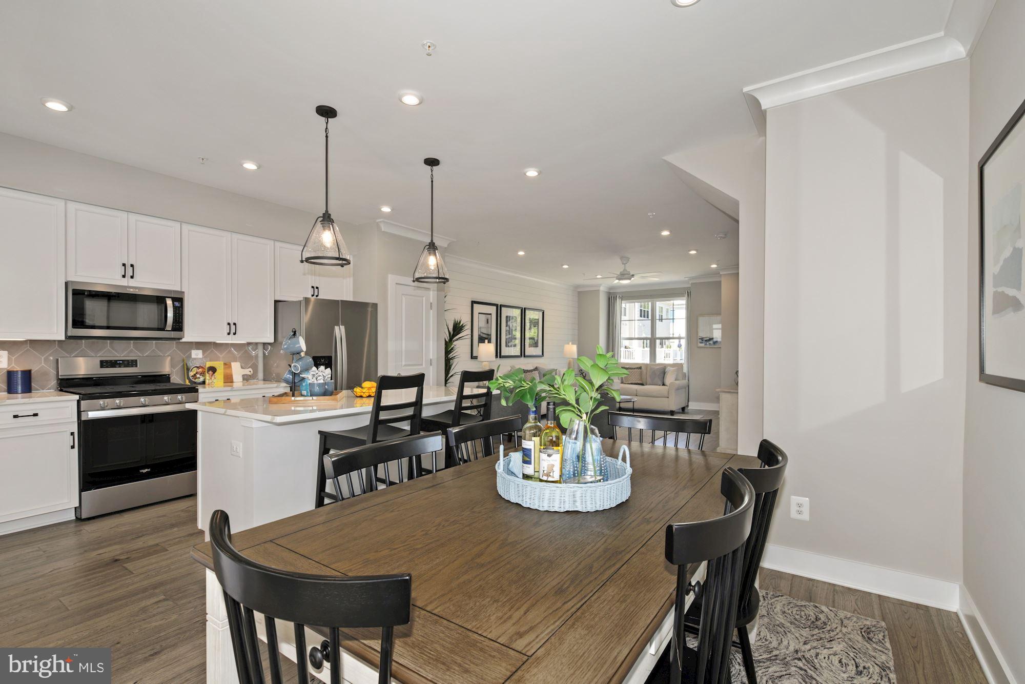4 Riverside Wharf Cambridge, MD 21613 - Photo 11 of 28 a kitchen with a dining table chairs stainless steel appliances and cabinets