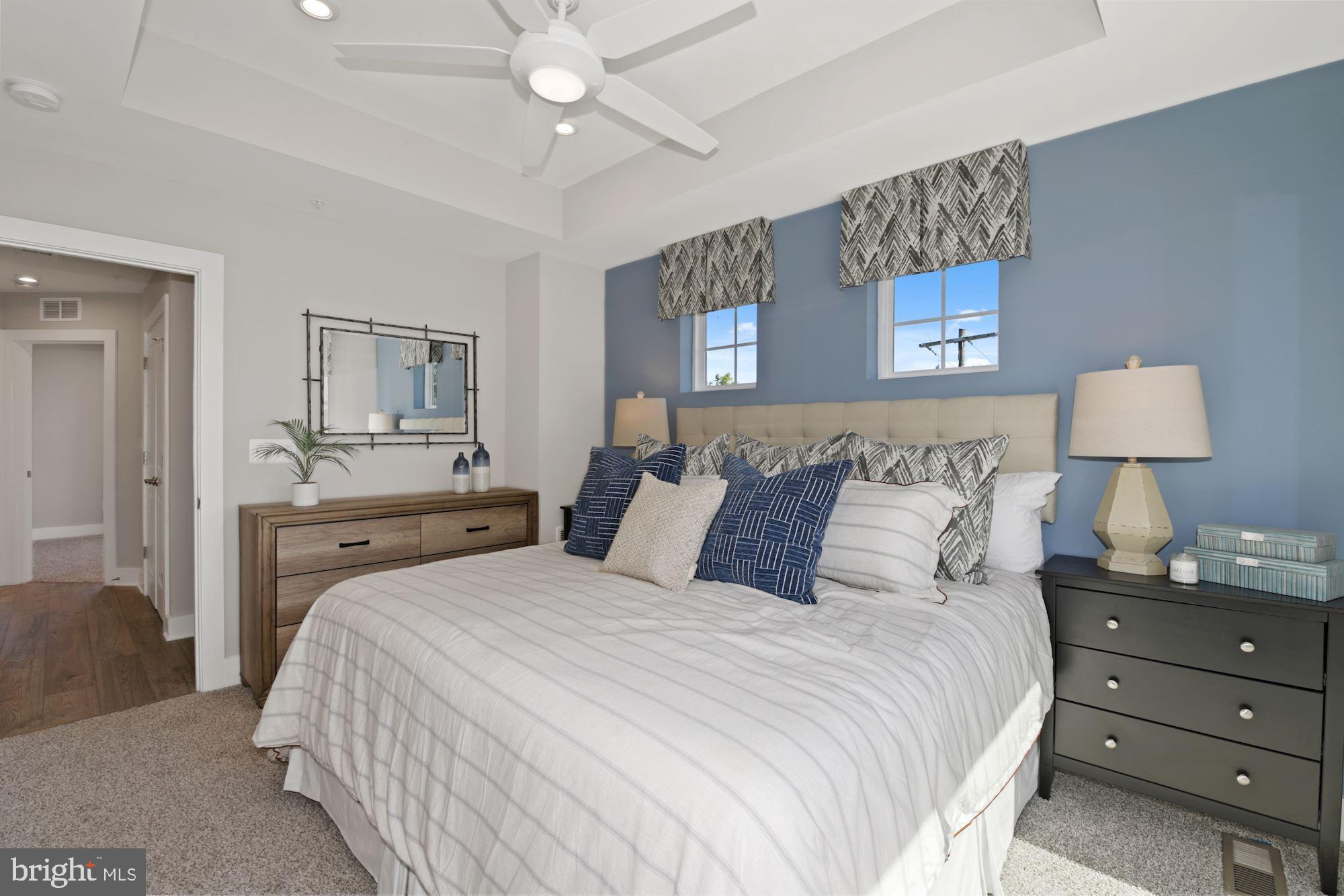 4 Riverside Wharf Cambridge, MD 21613 - Photo 16 of 28 a bedroom with a bed and a lamp on dresser