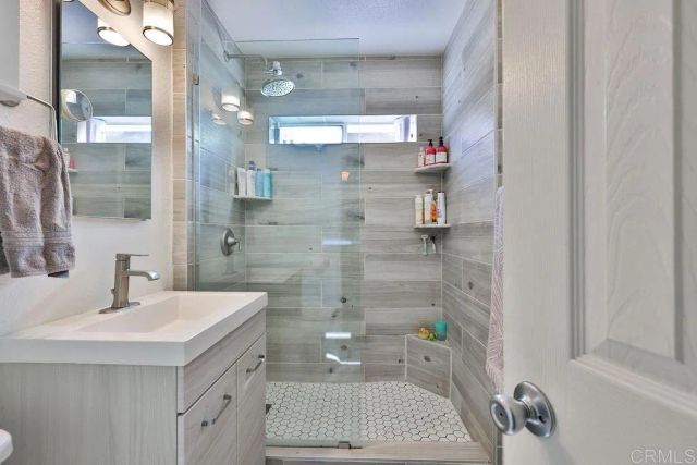 a bathroom with a sink a toilet and shower