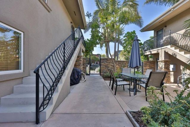 a view of a patio with couches table and chairs and potted plants