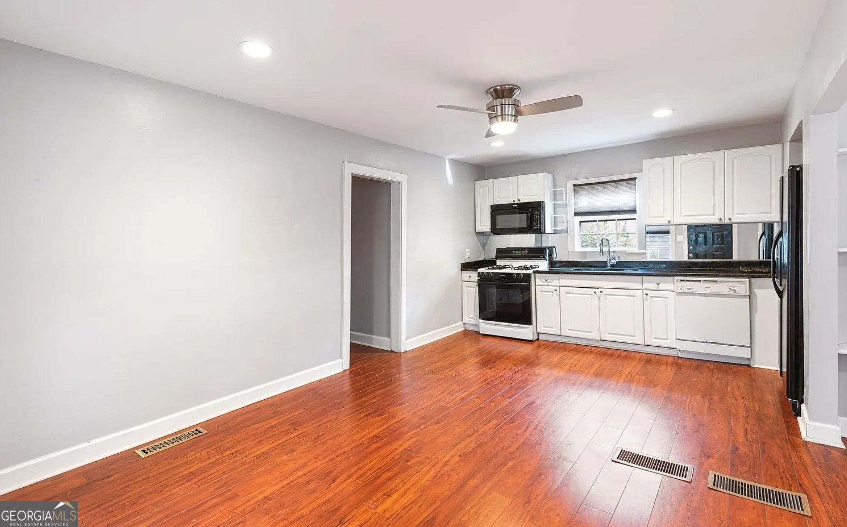 1143 United Avenue Southeast, Unit B Atlanta, GA 30316 - Photo 11 of 17 a kitchen with granite countertop a stove and a microwave
