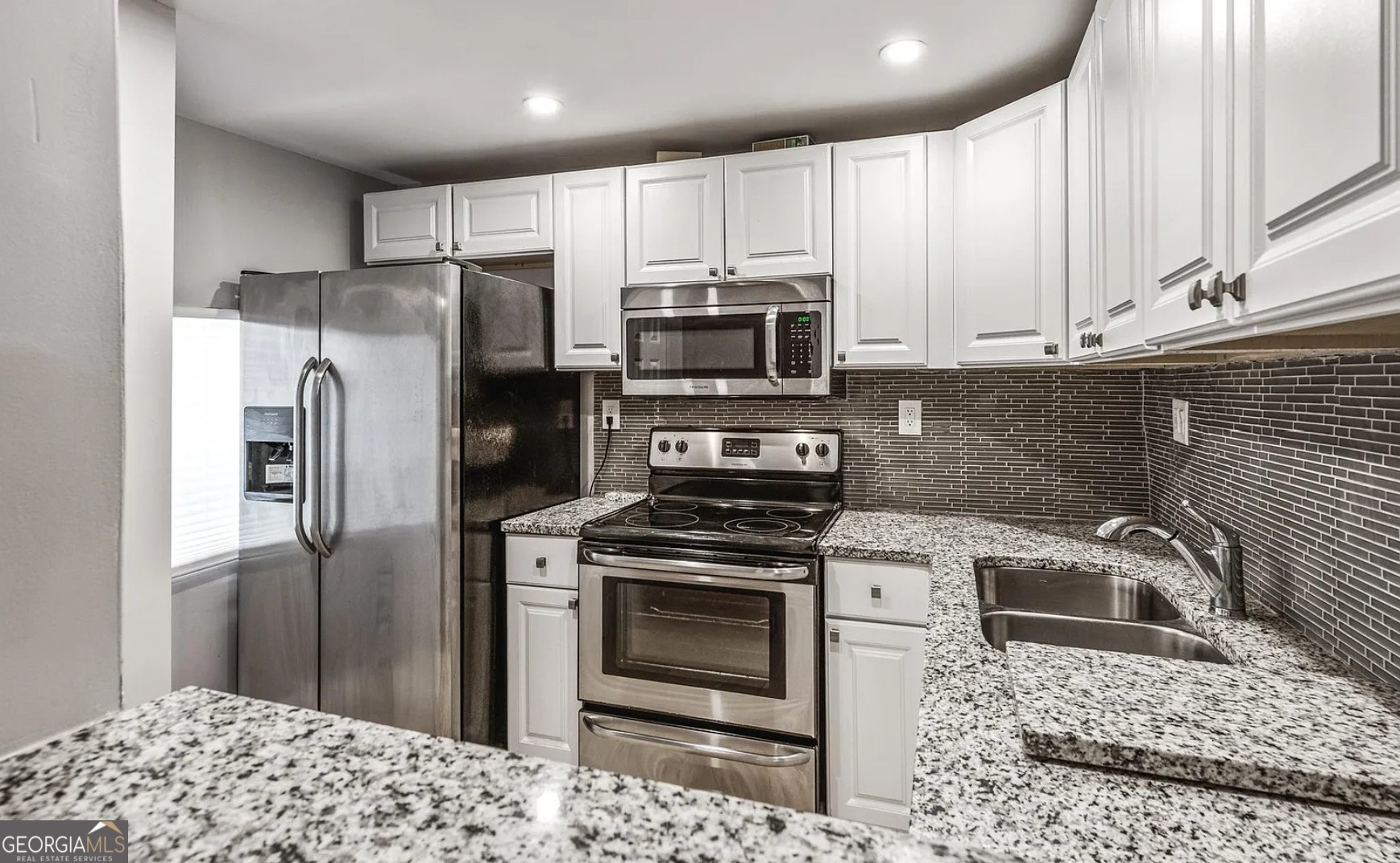 1143 United Avenue Southeast, Unit B Atlanta, GA 30316 - Photo 12 of 17 a kitchen with a sink stove and refrigerator