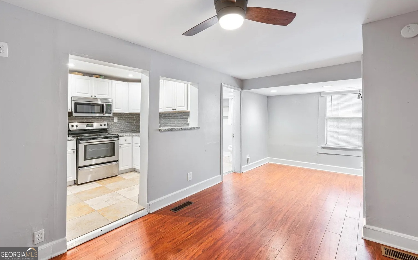 1143 United Avenue Southeast, Unit B Atlanta, GA 30316 - Photo 14 of 17 a view of empty room with kitchen and wooden floor