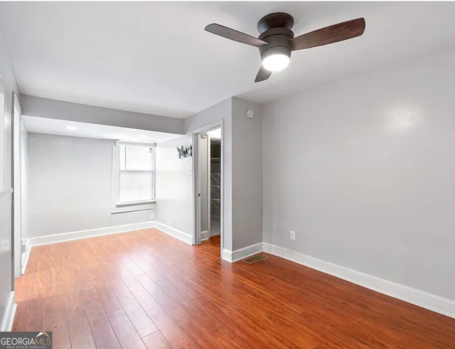 1143 United Avenue Southeast, Unit B Atlanta, GA 30316 - Photo 15 of 17 a view of an empty room with wooden floor ceiling fan