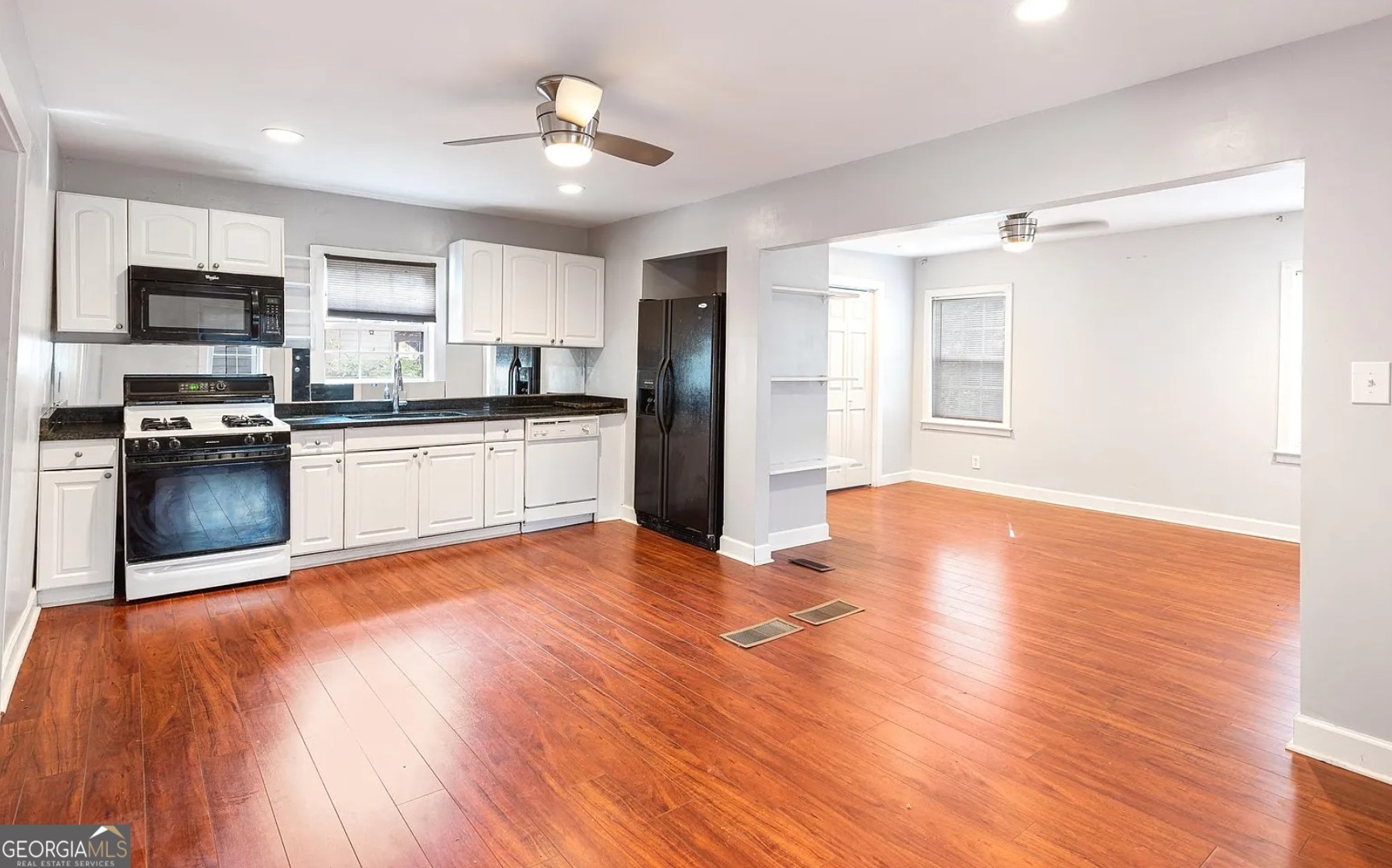 1143 United Avenue Southeast, Unit B Atlanta, GA 30316 - Photo 2 of 17 a kitchen with stainless steel appliances granite countertop a refrigerator a stove top oven a sink and dishwasher with wooden floor
