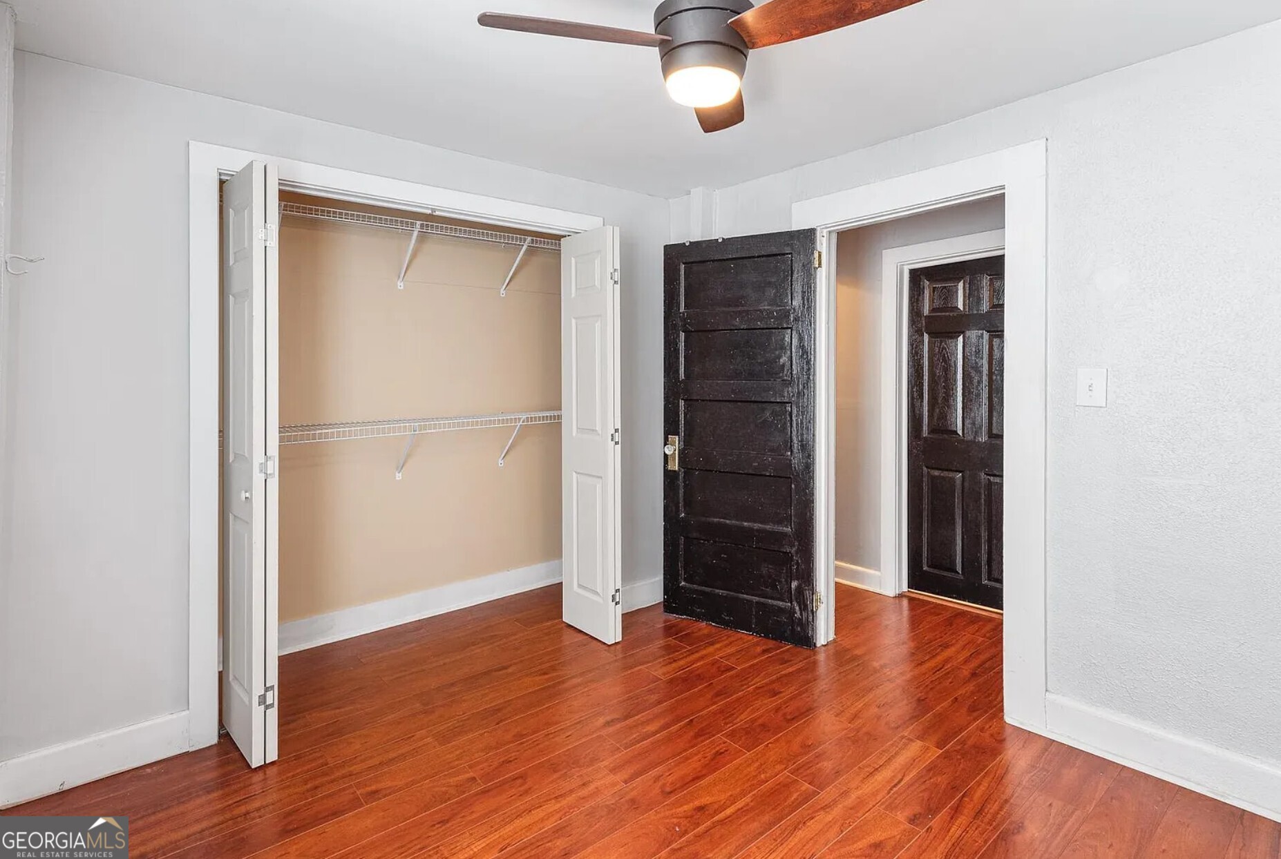 1143 United Avenue Southeast, Unit B Atlanta, GA 30316 - Photo 7 of 17 an empty room with wooden floor closet and windows