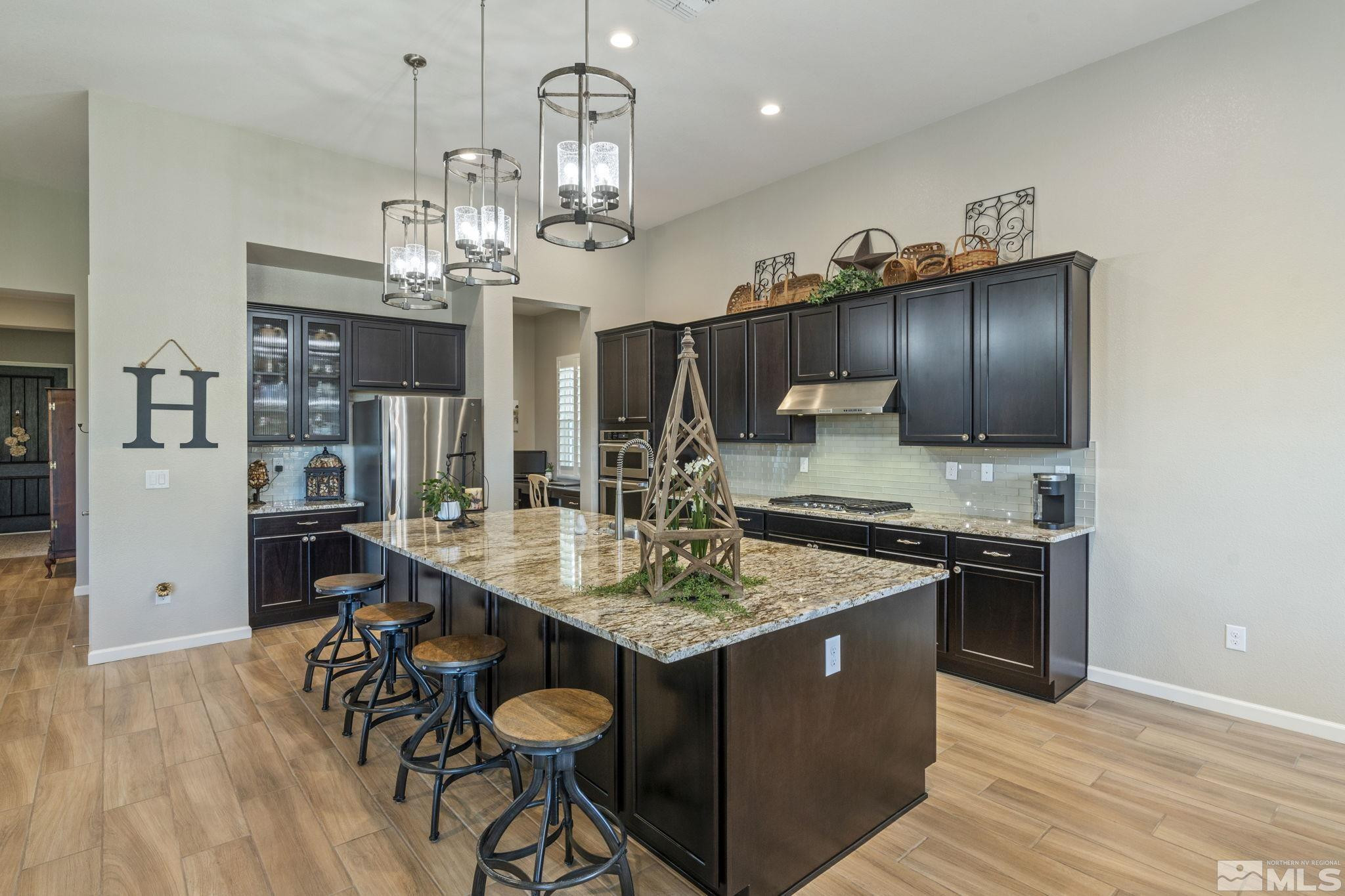 2420 Buttermere Court Reno, NV 89521 - Photo 12 of 40 a kitchen with stainless steel appliances granite countertop a sink stove and refrigerator