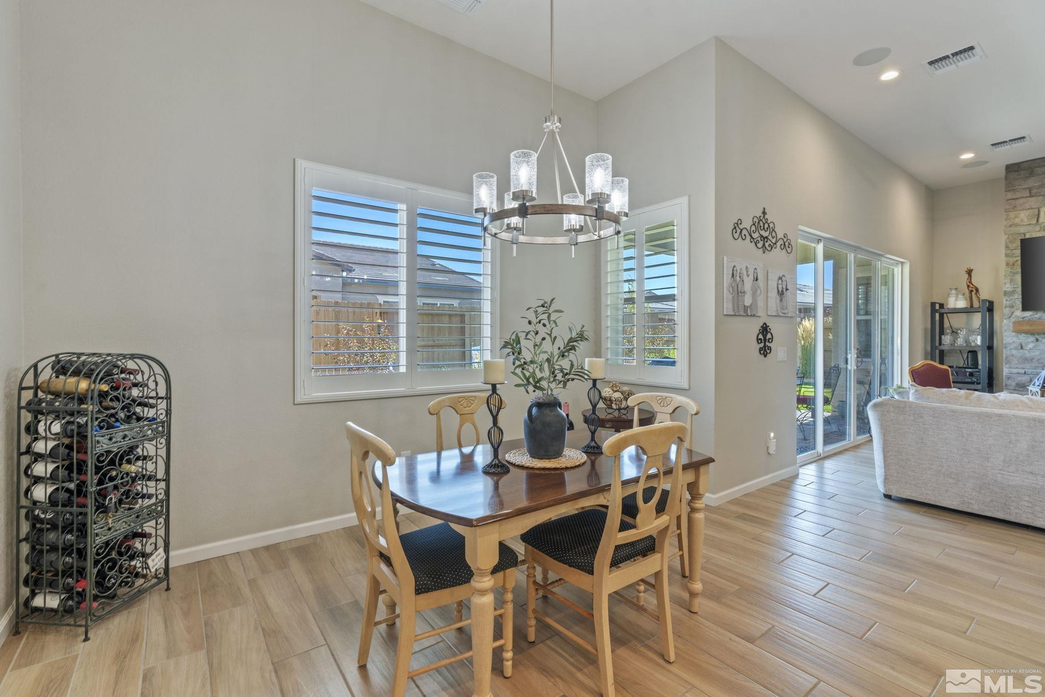 2420 Buttermere Court Reno, NV 89521 - Photo 15 of 40 a dining room with furniture a chandelier and wooden floor