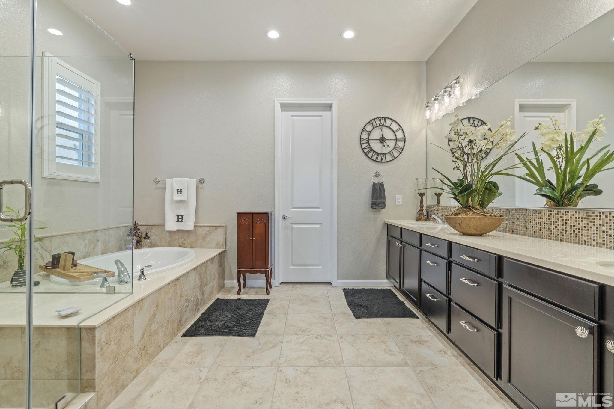 2420 Buttermere Court Reno, NV 89521 - Photo 23 of 40 a spacious bathroom with a tub sink and mirror