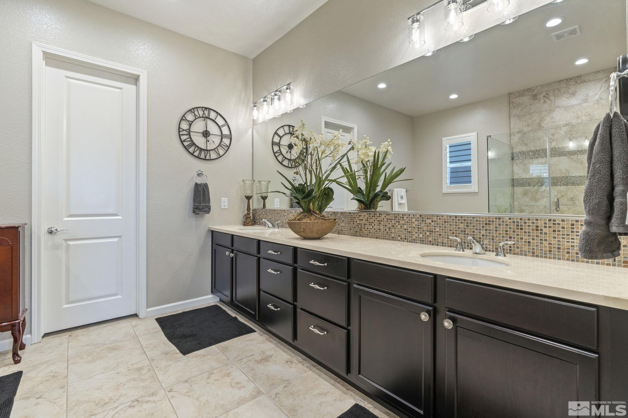 2420 Buttermere Court Reno, NV 89521 - Photo 24 of 40 a bathroom with a sink a mirror and a window