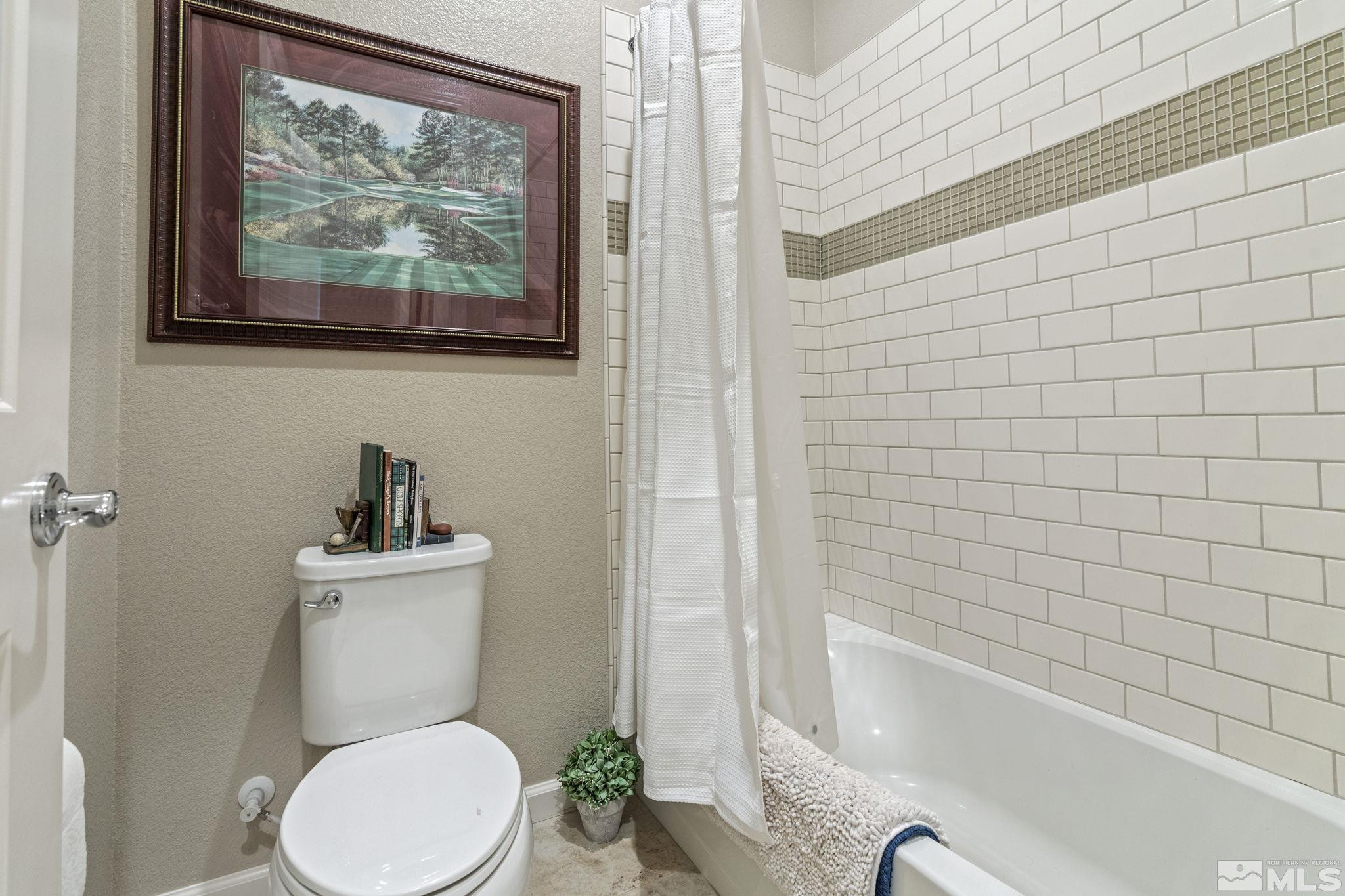 2420 Buttermere Court Reno, NV 89521 - Photo 29 of 40 a white toilet sitting next to a bath tub and a shower
