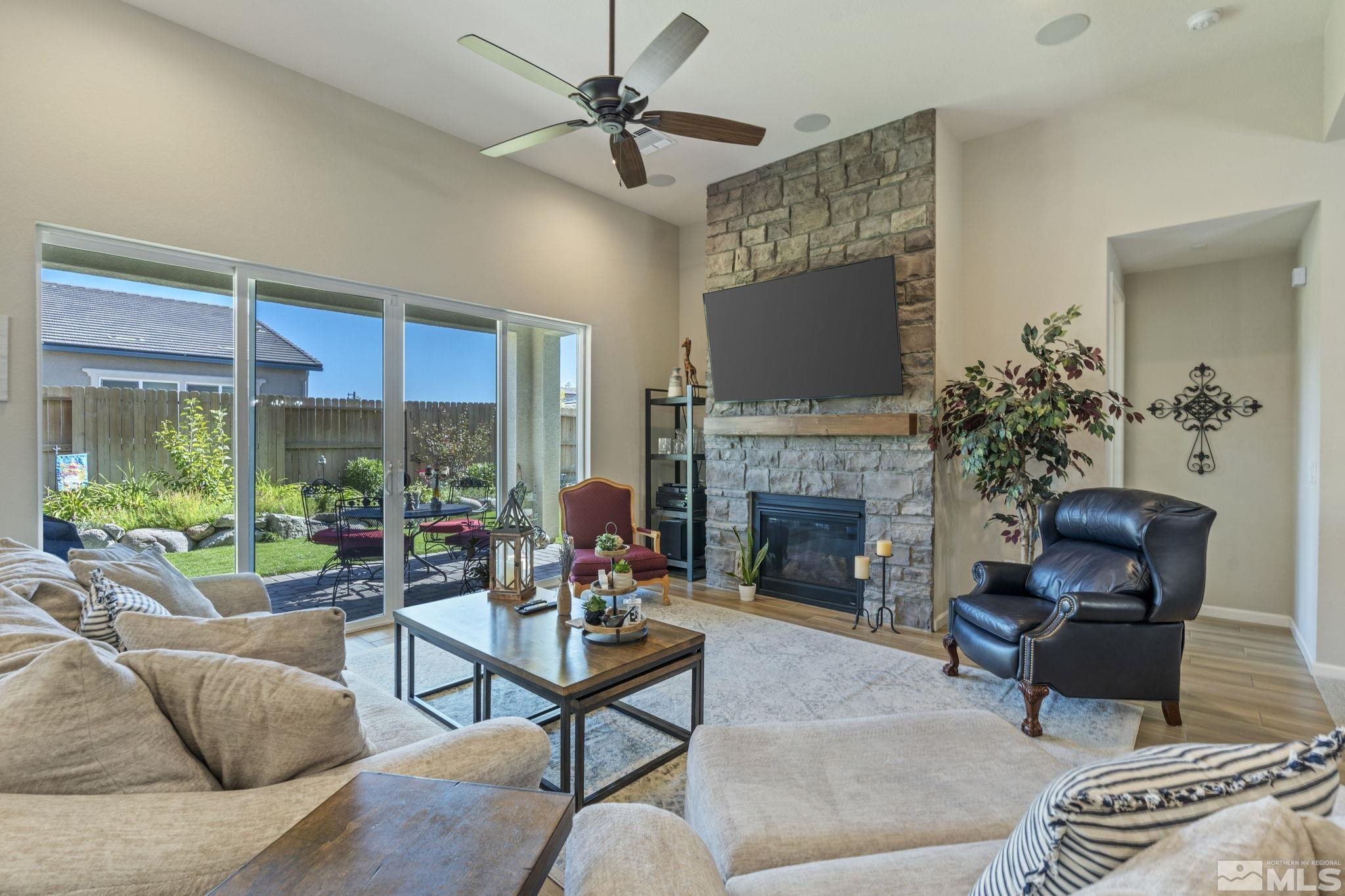 2420 Buttermere Court Reno, NV 89521 - Photo 6 of 40 a living room with furniture a fireplace and a floor to ceiling window