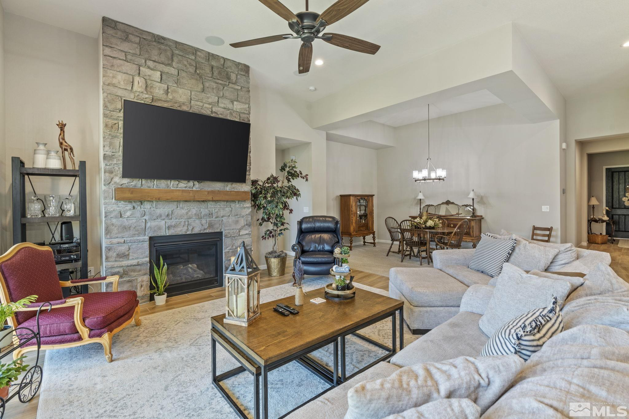 2420 Buttermere Court Reno, NV 89521 - Photo 7 of 40 a living room with furniture a flat screen tv and a fireplace