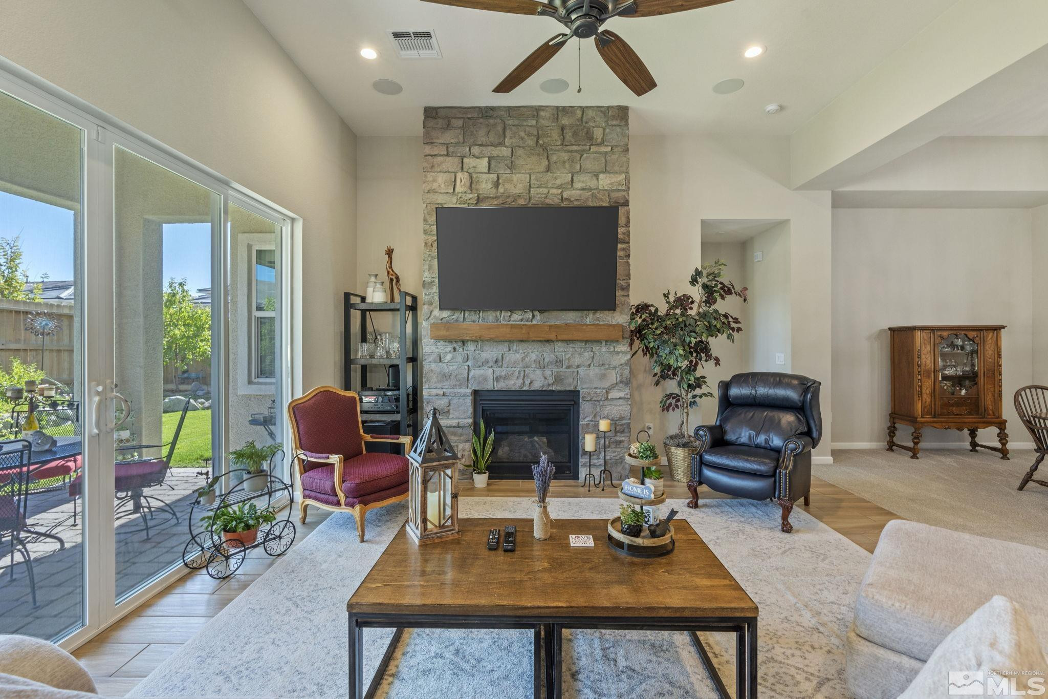 2420 Buttermere Court Reno, NV 89521 - Photo 8 of 40 a living room with furniture a table and a fireplace