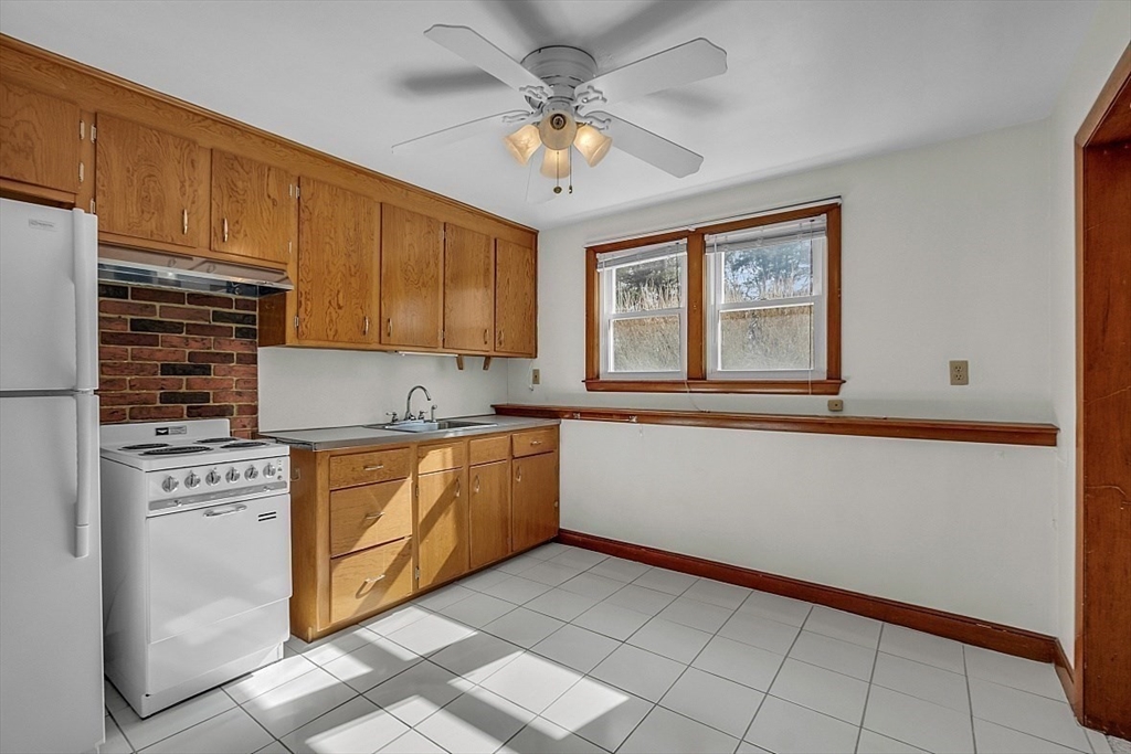 29 Meriam Road Concord, MA 01742 - Photo 21 of 24 a kitchen with stainless steel appliances granite countertop a stove a sink and a refrigerator