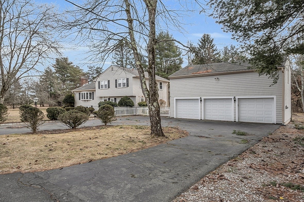 29 Meriam Road Concord, MA 01742 - Photo 6 of 24 a view of a house with a yard covered in snow