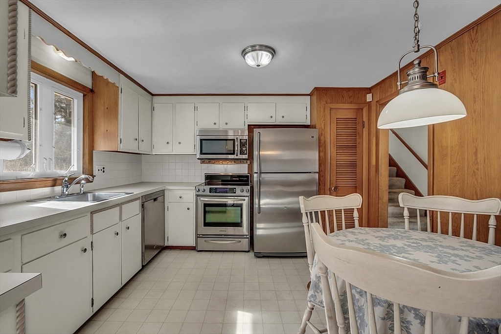 29 Meriam Road Concord, MA 01742 - Photo 8 of 24 a kitchen with stainless steel appliances a refrigerator sink and stove