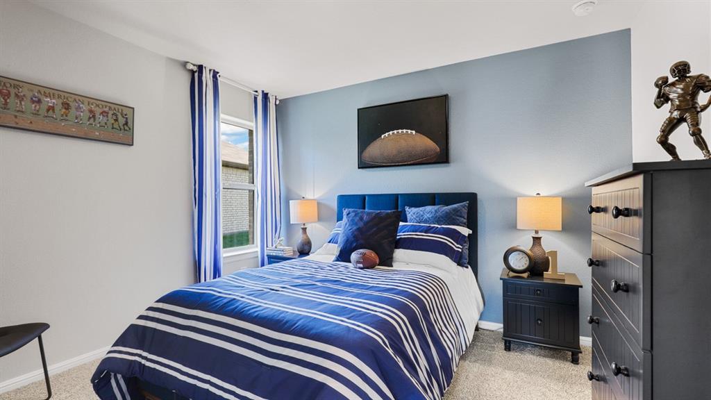 16448 Hudson Pr Way Justin, TX 76247 - Photo 29 of 40 a bedroom with a bed and a lamp