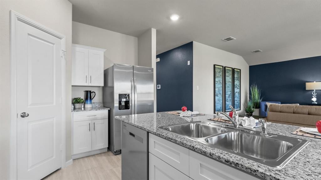16448 Hudson Pr Way Justin, TX 76247 - Photo 3 of 40 a kitchen with stainless steel appliances granite countertop a sink and a refrigerator