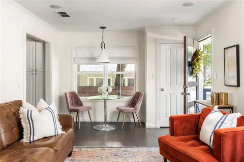 a living room with furniture wooden floor and a chandelier
