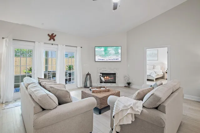 a living room with furniture ceiling fan and a window