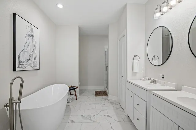 a spacious bathroom with a double vanity sink and a mirror
