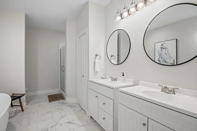 a bathroom with a double vanity sink and a mirror