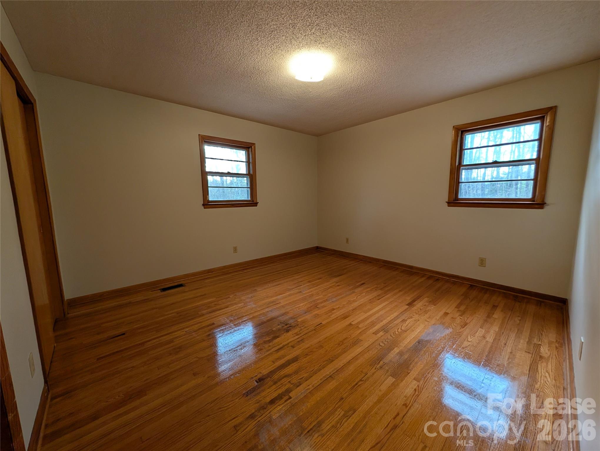 805 Edgewood Road Bessemer City, NC 28016 - Photo 11 of 19 an empty room with wooden floor and windows