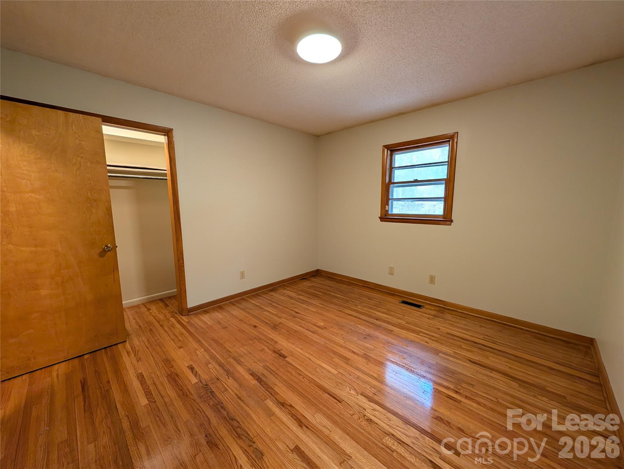 805 Edgewood Road Bessemer City, NC 28016 - Photo 14 of 19 a view of empty room with wooden floor and fan