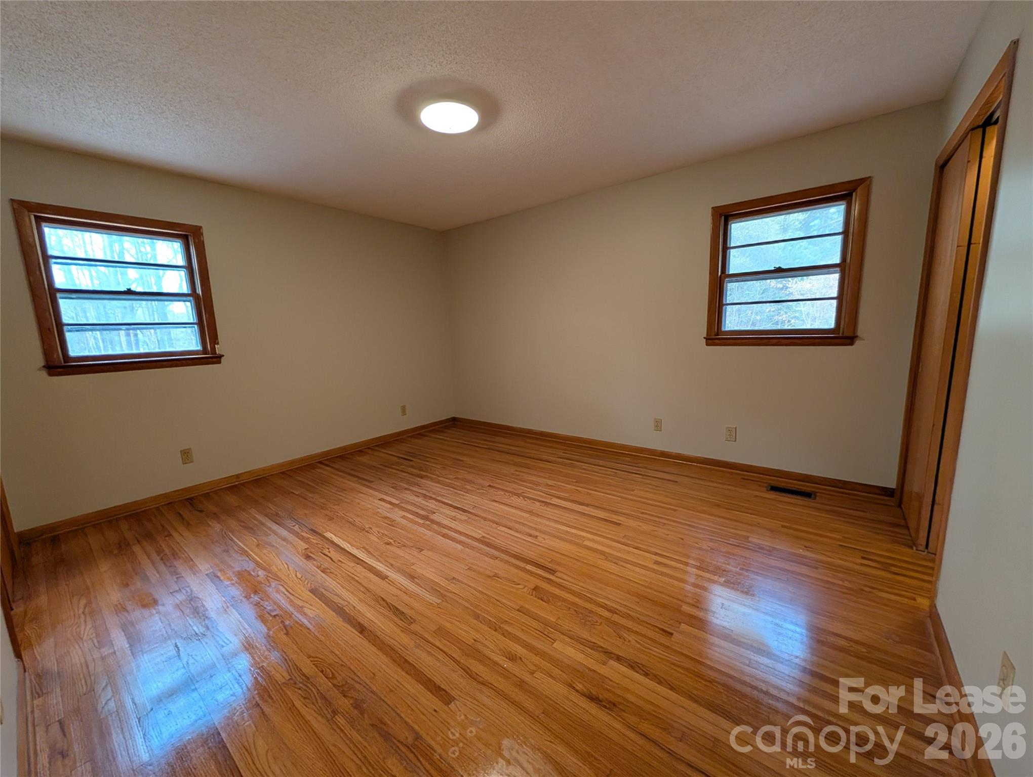 805 Edgewood Road Bessemer City, NC 28016 - Photo 15 of 19 a view of an empty room with wooden floor and a window