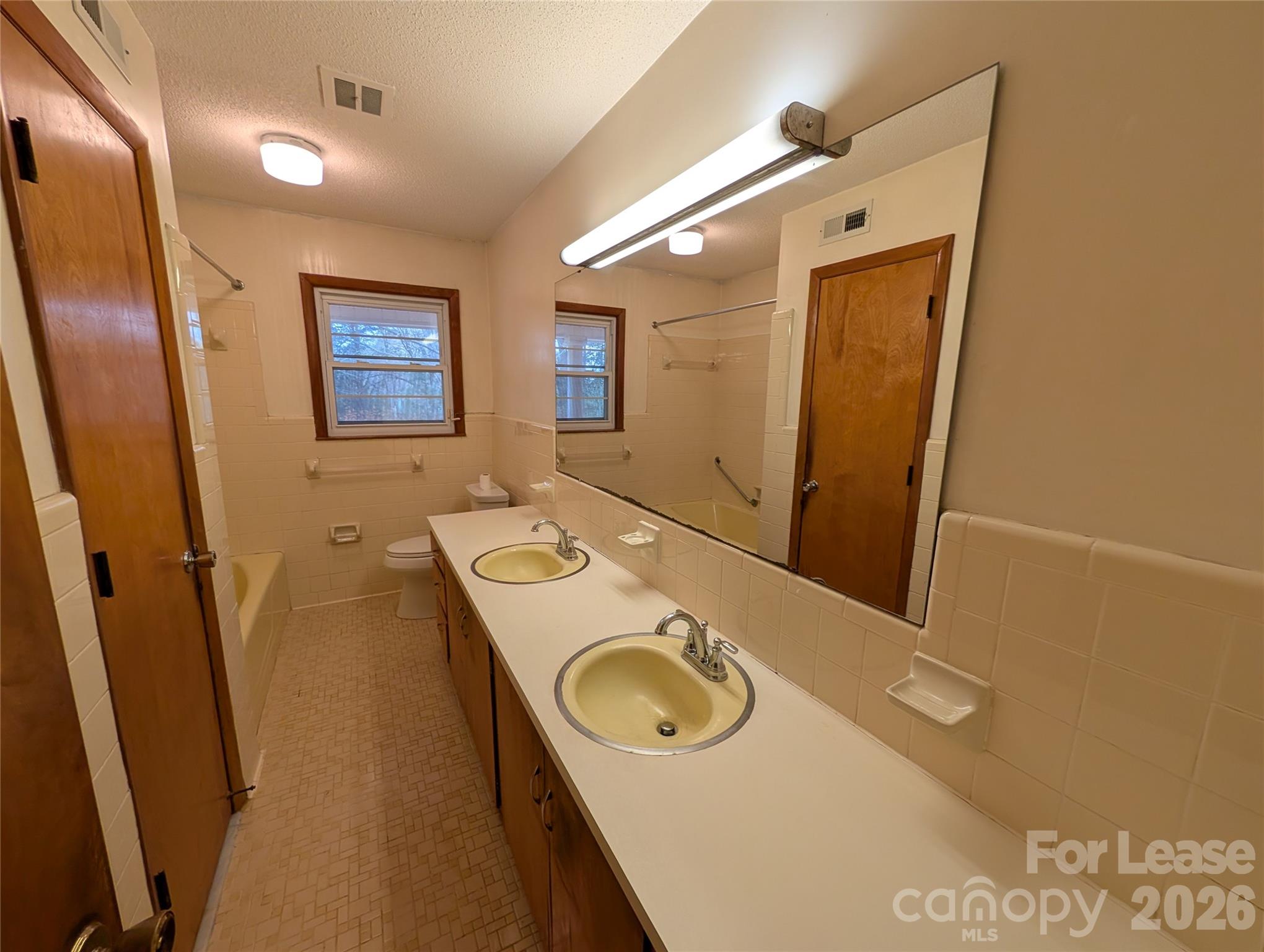 805 Edgewood Road Bessemer City, NC 28016 - Photo 16 of 19 a bathroom with a sink a mirror and a toilet