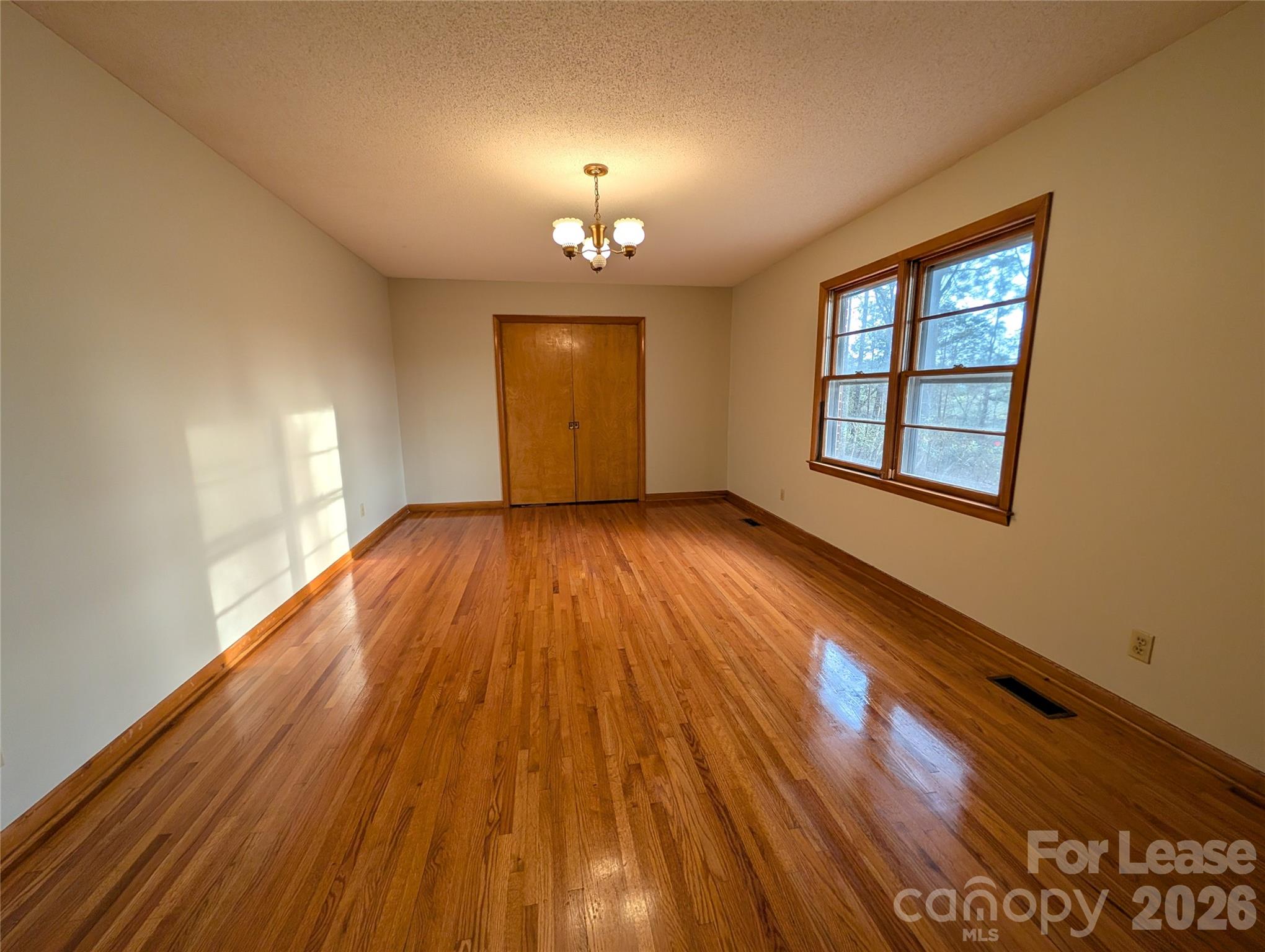 805 Edgewood Road Bessemer City, NC 28016 - Photo 3 of 19 wooden floor in an empty room with a window