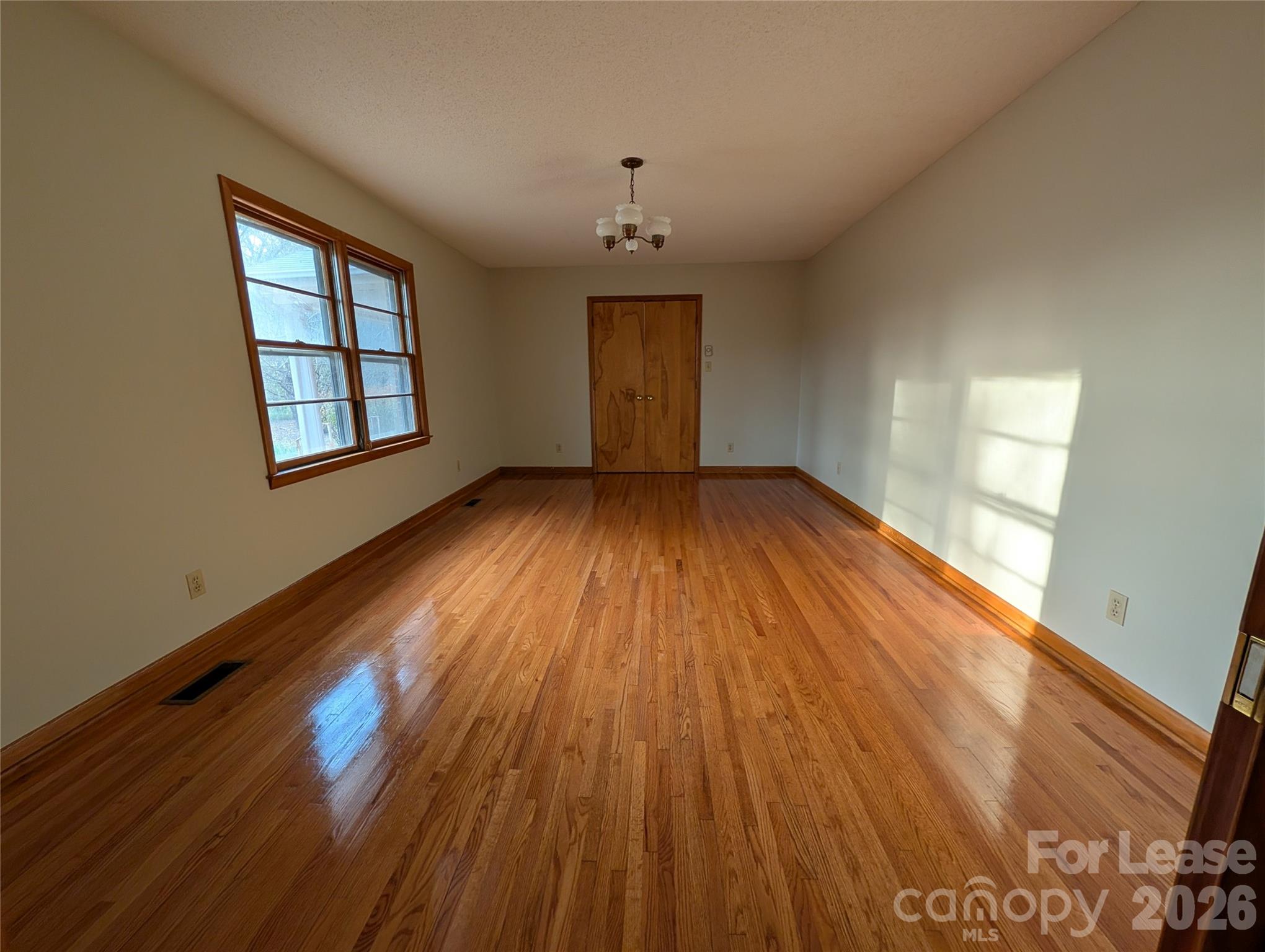 805 Edgewood Road Bessemer City, NC 28016 - Photo 4 of 19 a view of an empty room with wooden floor and a window
