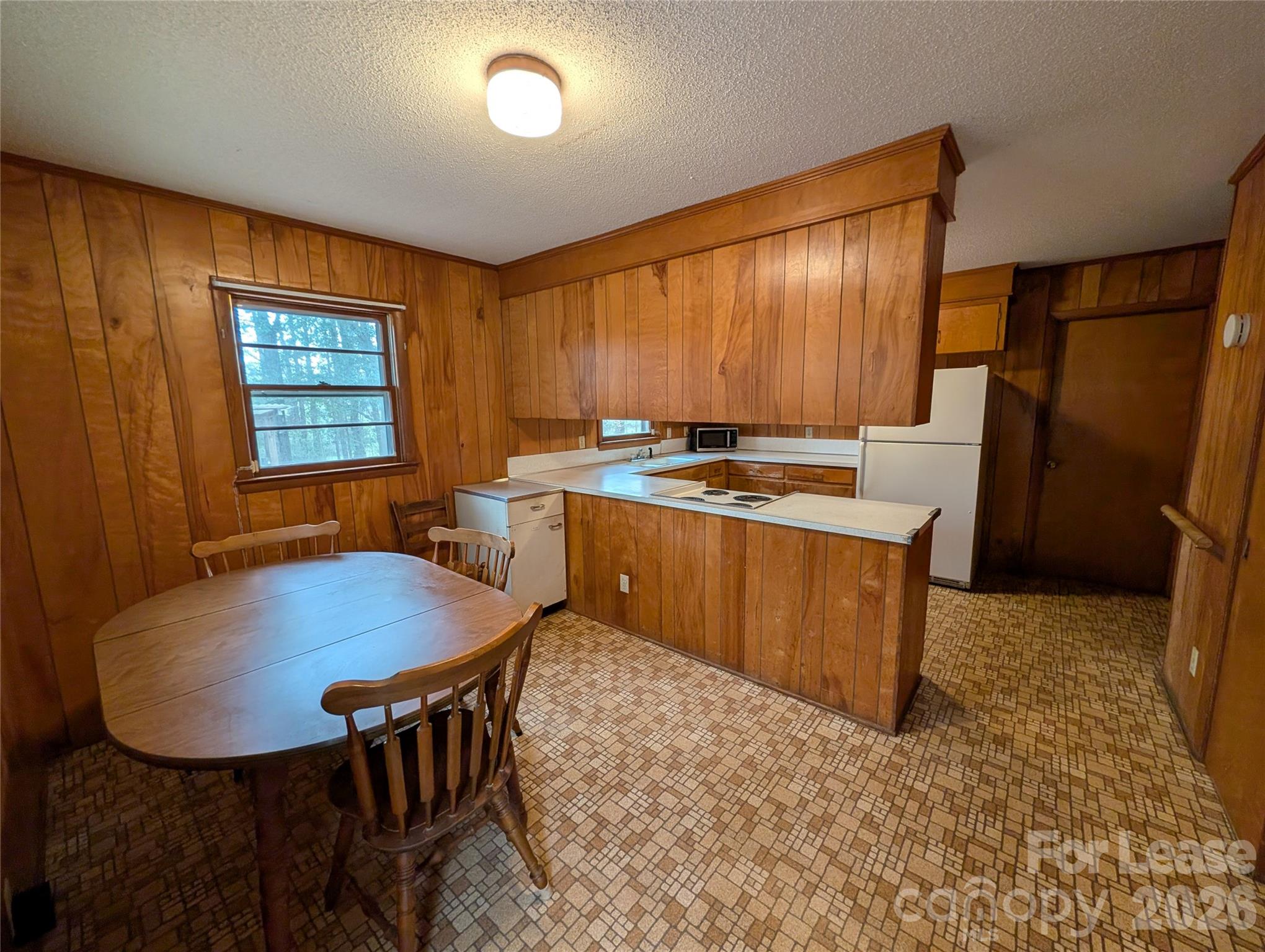805 Edgewood Road Bessemer City, NC 28016 - Photo 6 of 19 a dining room with a table chairs and a refrigerator