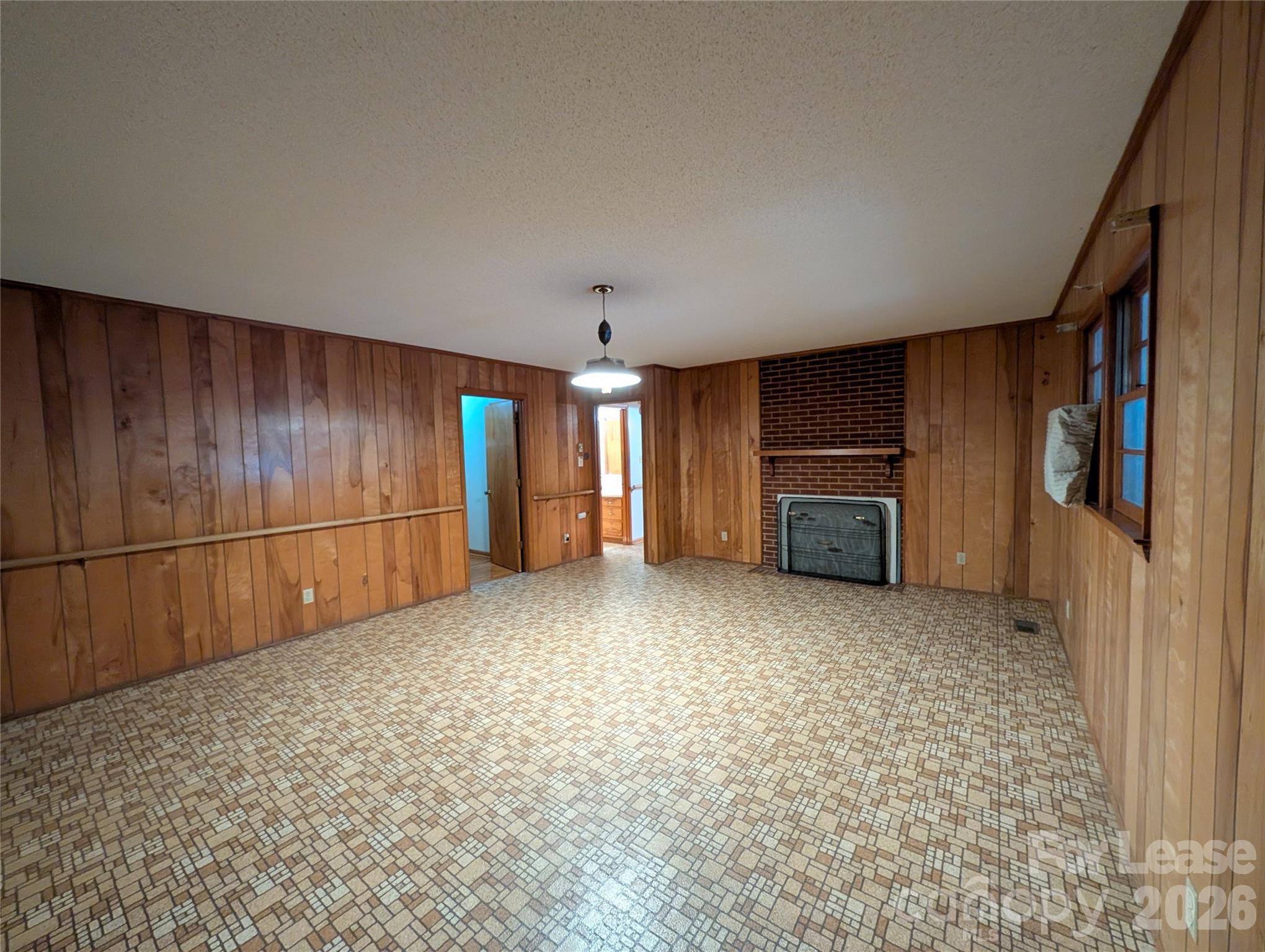 805 Edgewood Road Bessemer City, NC 28016 - Photo 7 of 19 a view of an empty room with a fireplace
