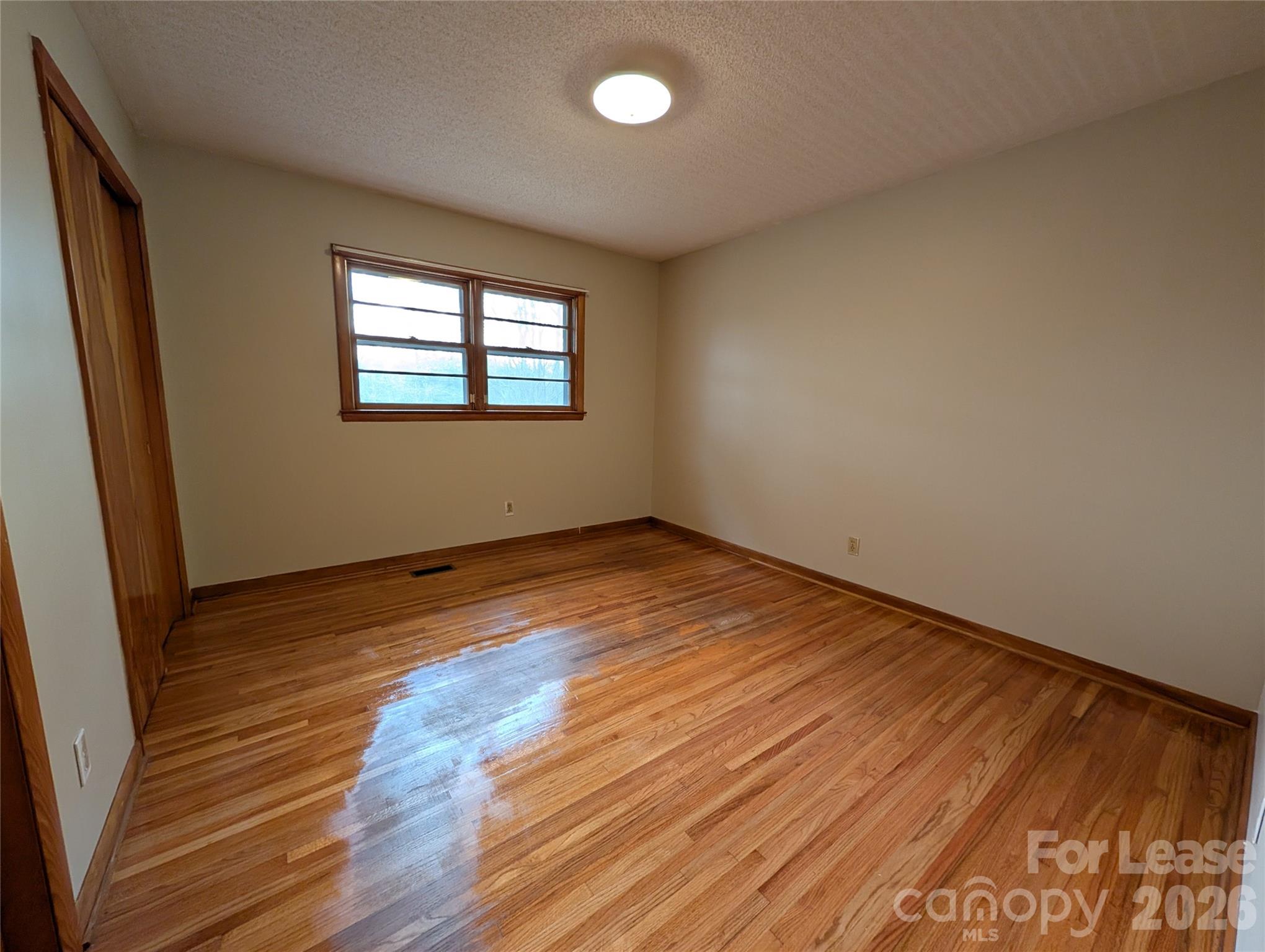 805 Edgewood Road Bessemer City, NC 28016 - Photo 10 of 19 wooden floor in an empty room with a window