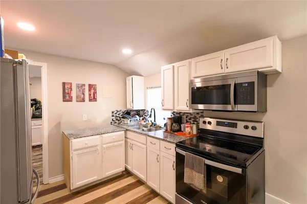 a kitchen with a sink stove and microwave