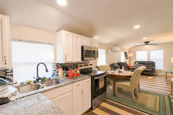 a kitchen with a sink stove and cabinets