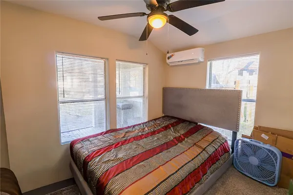 a bedroom with a bed and window