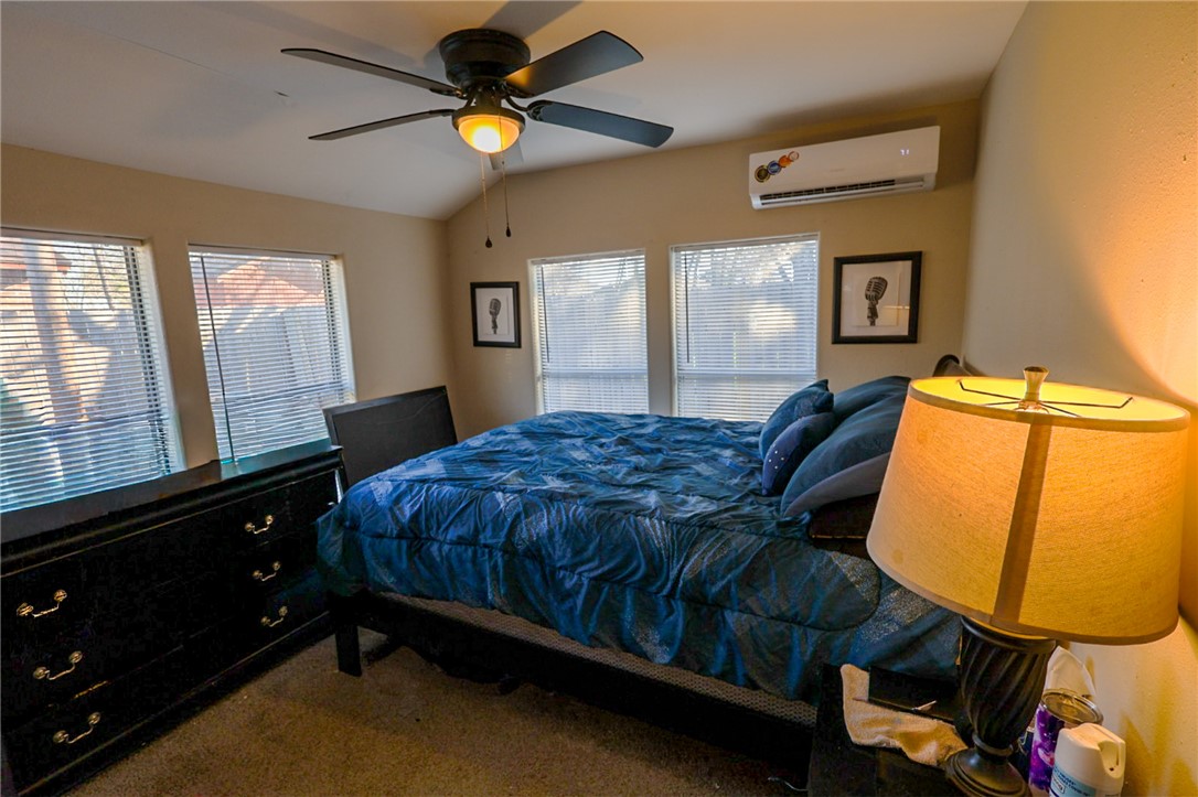 1211 West 18th Street Bryan, TX 77803 - Photo 7 of 12 a bed room with a bed and a window