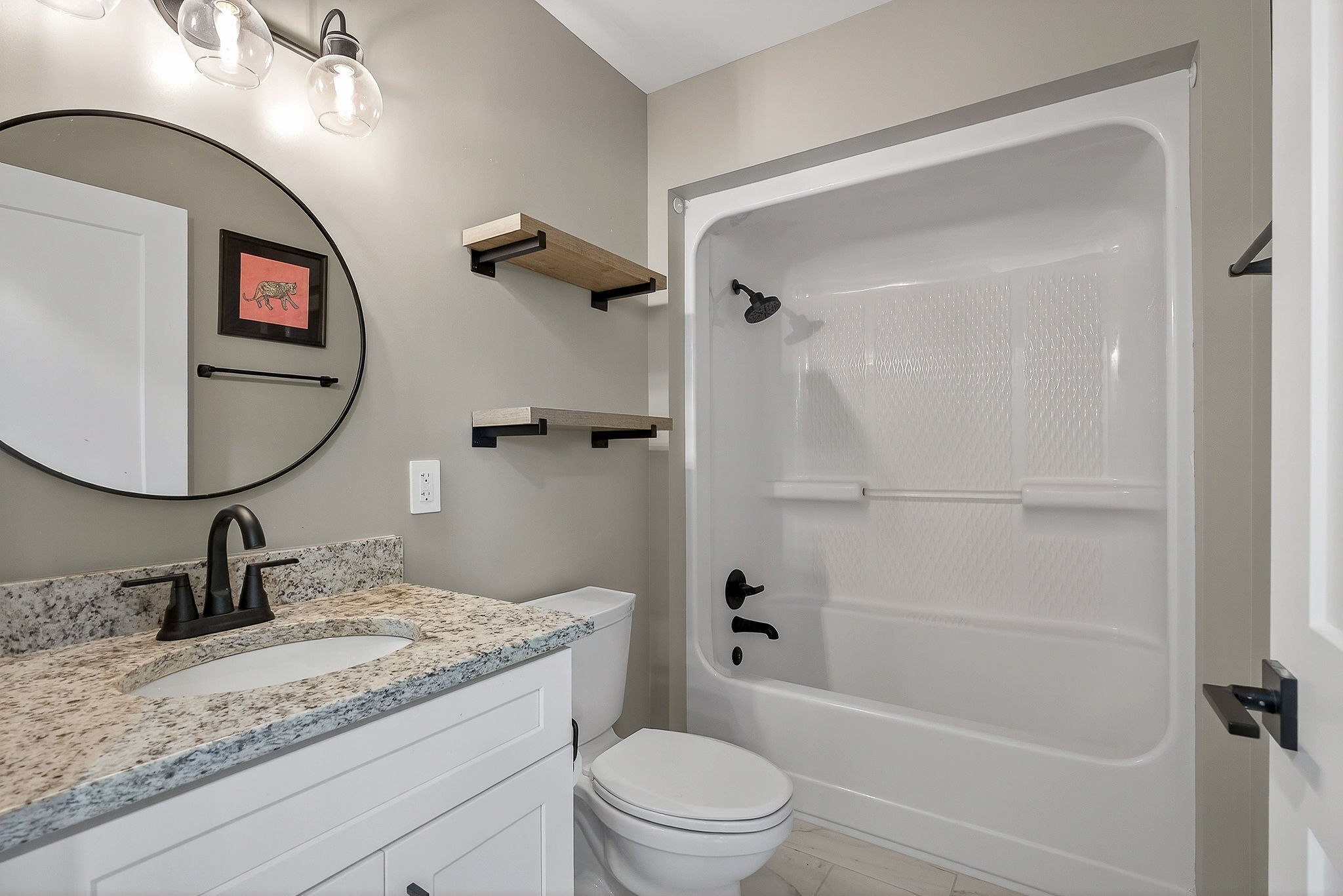 3857 Baxter Road Baxter, TN 38544 - Photo 17 of 52 a bathroom with a granite countertop sink a mirror a toilet and shower