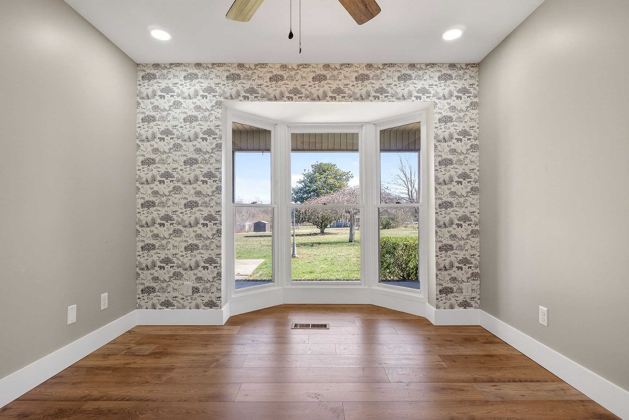 3857 Baxter Road Baxter, TN 38544 - Photo 21 of 52 an empty room with wooden floor and windows