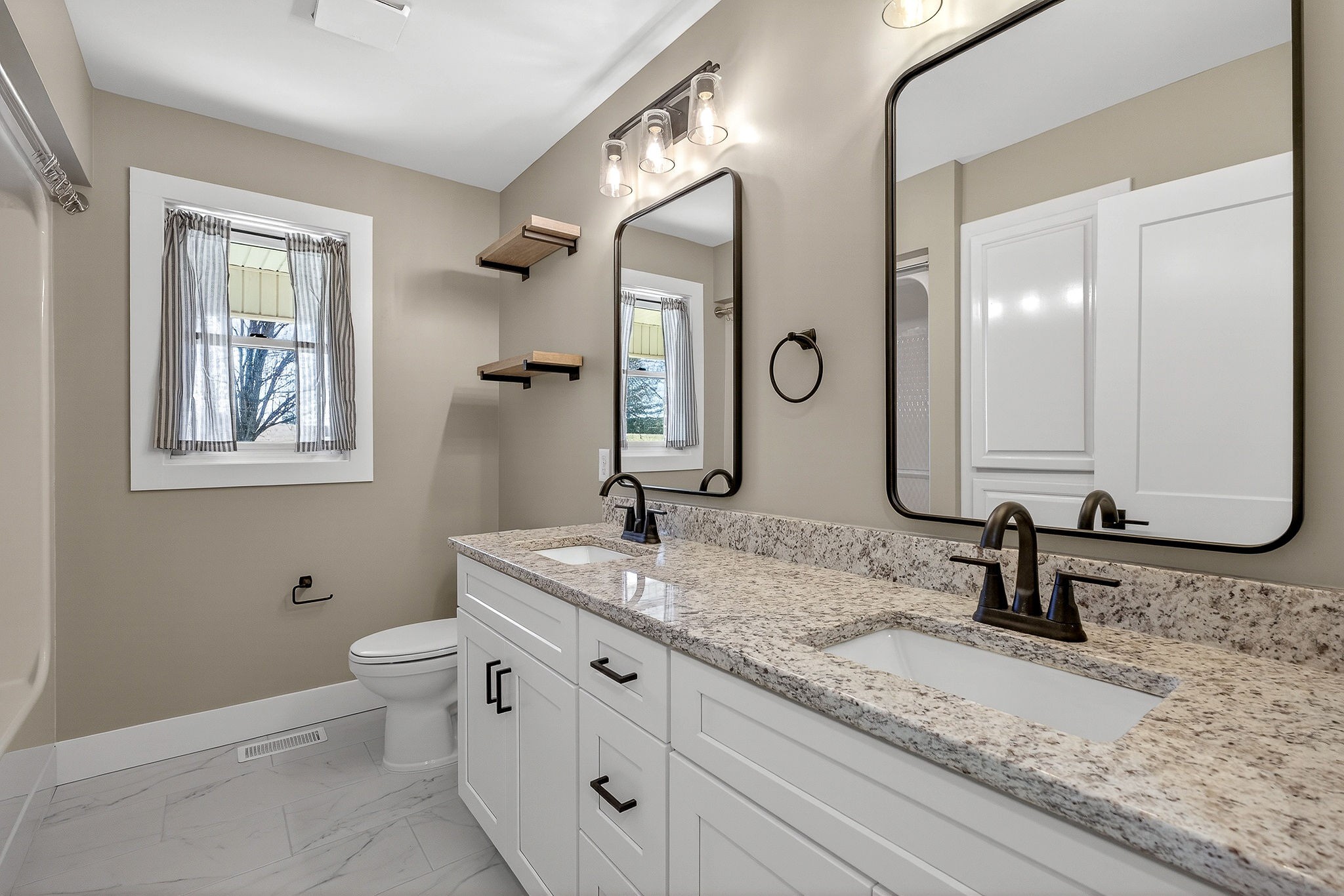 3857 Baxter Road Baxter, TN 38544 - Photo 22 of 52 a bathroom with double sink and a mirror