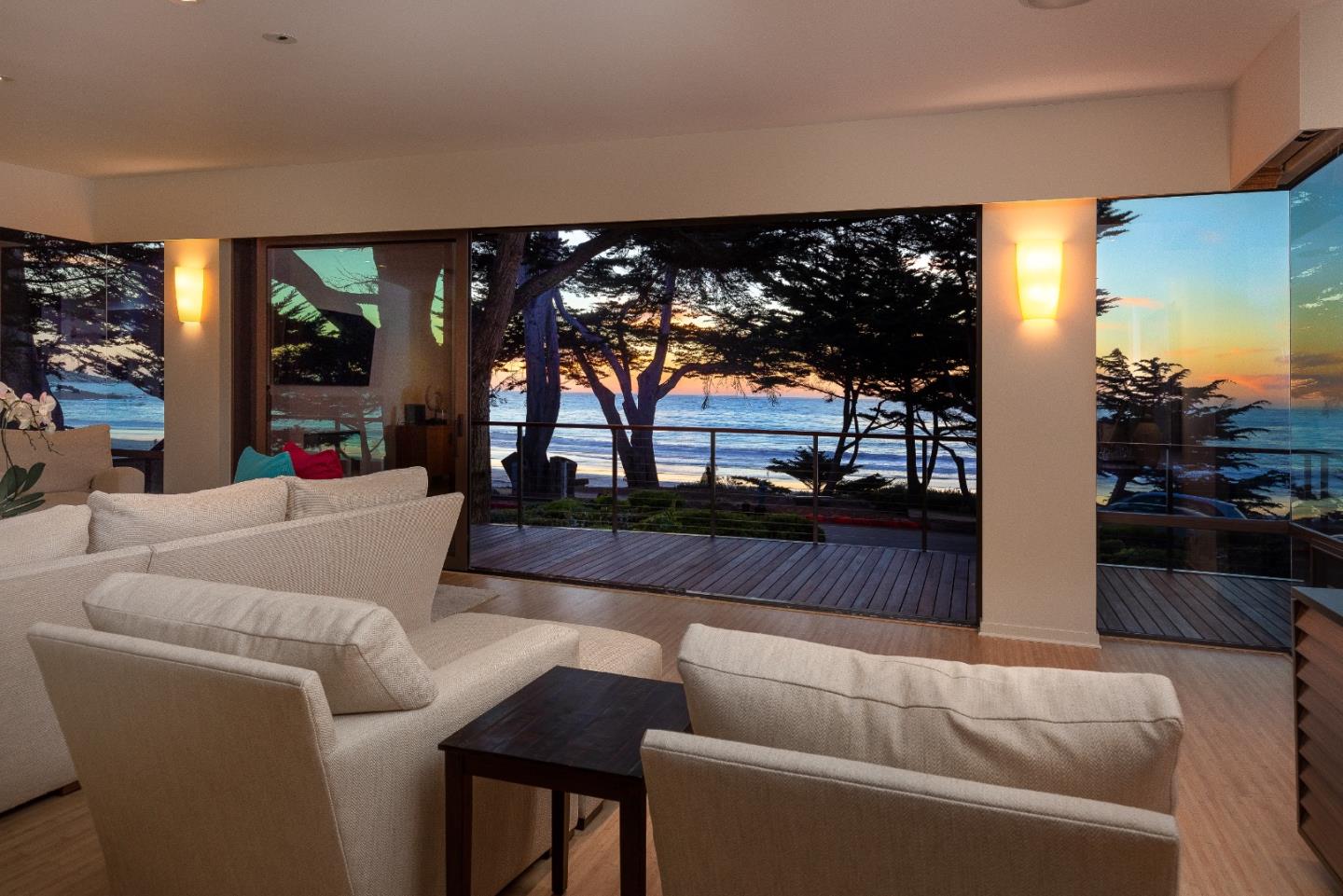 a living room with furniture a floor to ceiling window and a flat screen tv