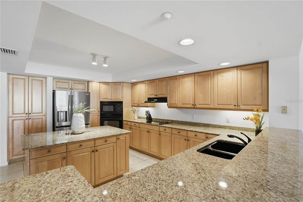 16326 Gulf Boulevard, Unit 307 Redington Beach, FL 33708 - Photo 7 of 43 a kitchen with sink refrigerator and microwave