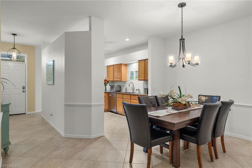 23164 Grassy Pine Drive Estero, FL 33928 - Photo 14 of 43 a view of a dining room with furniture and wooden floor