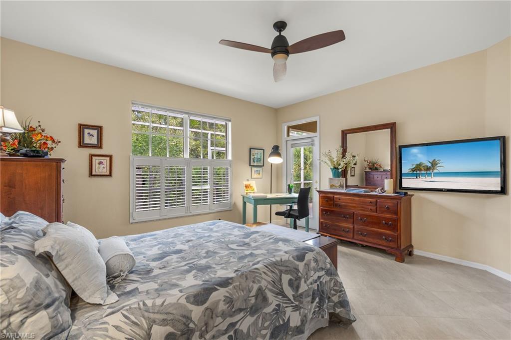 23164 Grassy Pine Drive Estero, FL 33928 - Photo 19 of 43 a bedroom with a large bed and a window