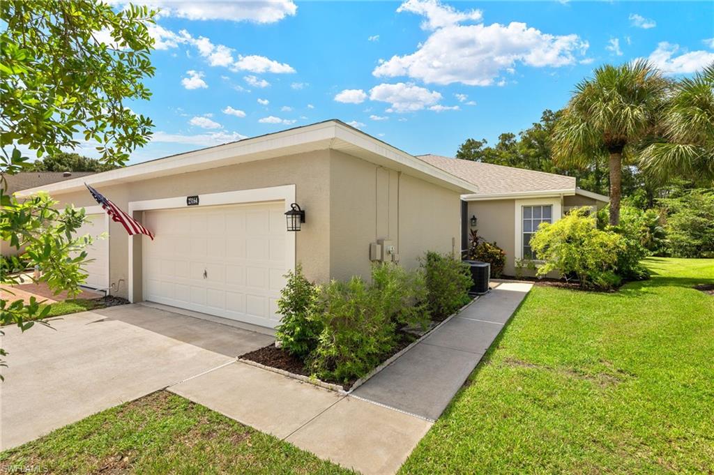 23164 Grassy Pine Drive Estero, FL 33928 - Photo 2 of 43 a view of a house with a yard