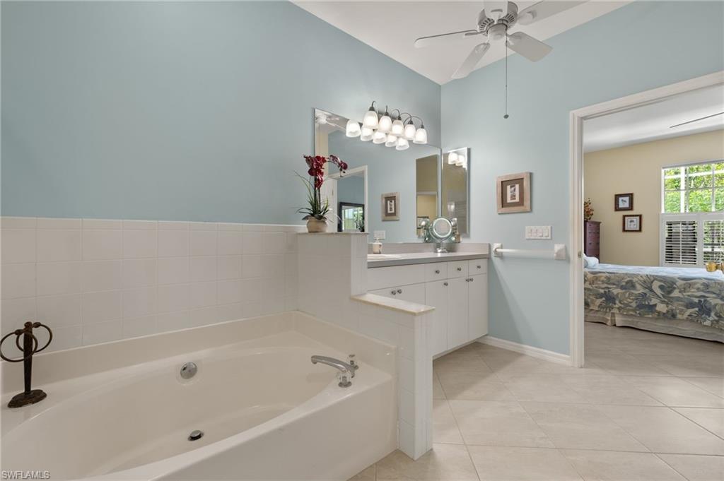 23164 Grassy Pine Drive Estero, FL 33928 - Photo 21 of 43 a spacious bathroom with a bathtub sink and mirror